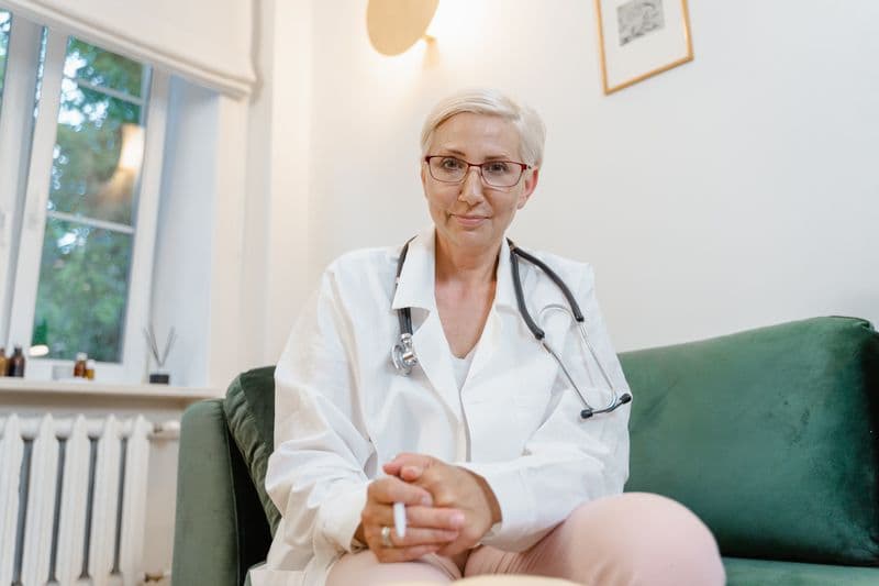 Portrait of Dr. Elena Sorensen, MD, FACOG, wearing a white coat and glasses
